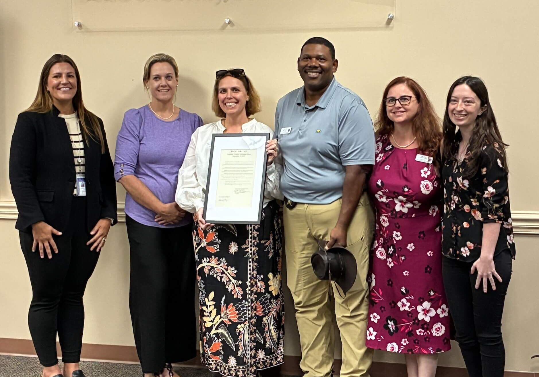Commissioner Alyson McCullough presents a proclamation to Micah's Place declaring October 2025 as Domestic Violence Awareness Month in Nassau County, FL.